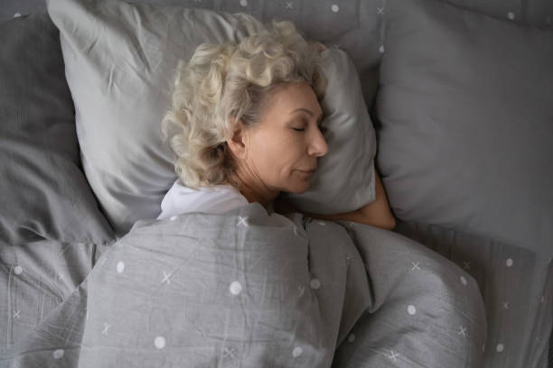istock Calm senior woman sleeping in comfortable home bed 1248182222