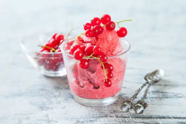 ice cream with berries in a glass on a table, selective focus