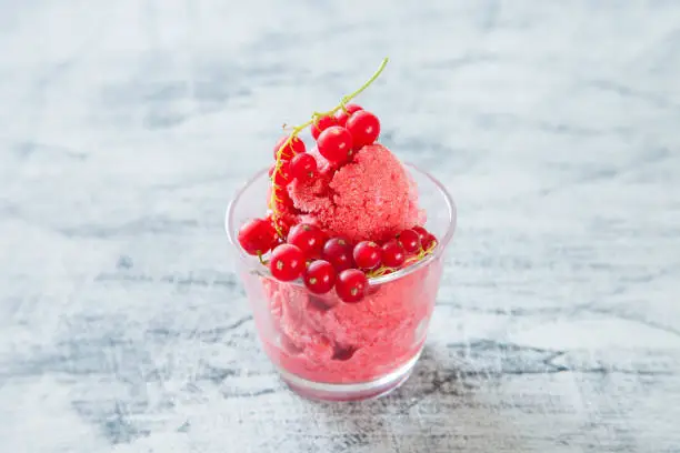 ice cream with berries in a glass on a table, selective focus