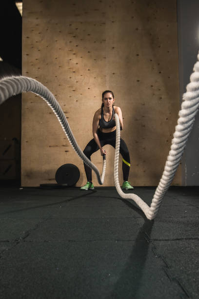 istock woman working out with battle ropes 1248182558