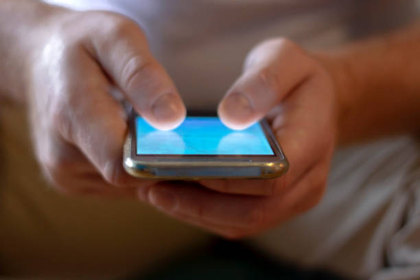 istock Modern new phone in hands of young man. 1248182721