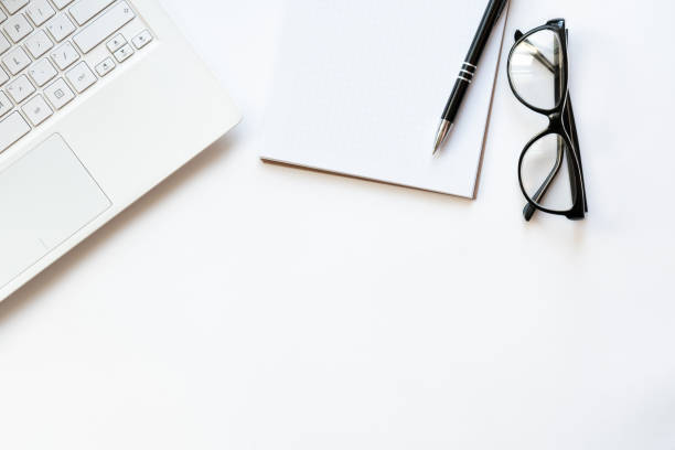 istock Workplace with notebook, glasses, pen and notepad on light white backround. Copy space. Top view. Concept business. 1248182746