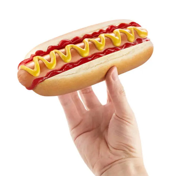 Photo of Delicious hot dog in male hand on white
