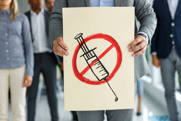 No vaccination! Unrecognizable businessman holding anti-vaccination banner. refusing photos stock pictures, royalty-free photos & images