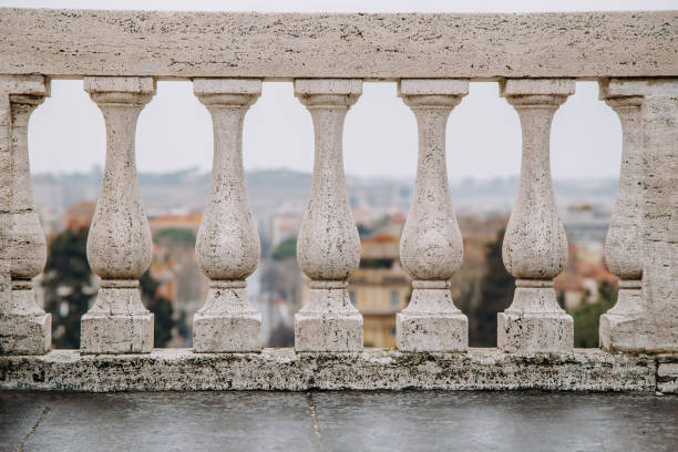 White traditional style balustrade. View through the columns to the city. Italy, Rome.