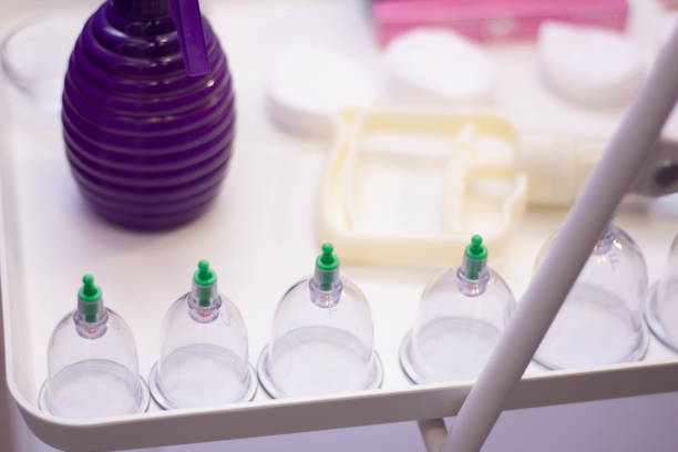 istock Hijama jars, a hijama pump and spray bottle stand on a table 1248189796