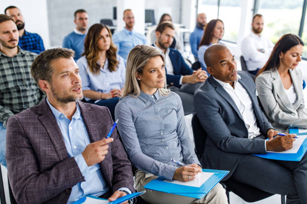 istock Large group of entrepreneurs attending a seminar in board room. 1248190850
