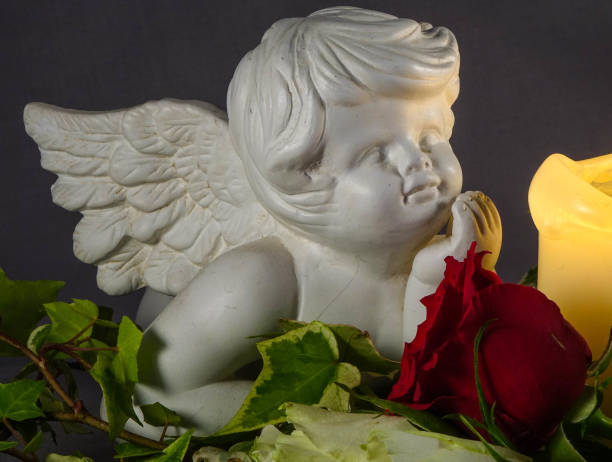 istock Angel, flower and burning candle on black background 1248190950