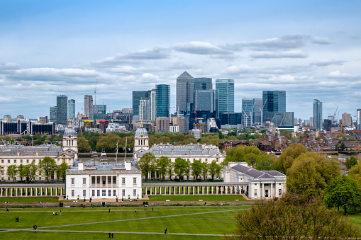 London, UK - May 13, 2022: General view of the Grenwich area from the Queen's house, with the Naval university and the Canary wharf skyline in the background