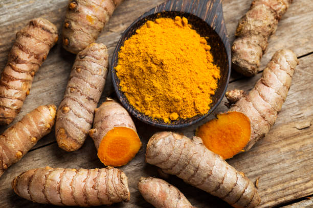 istock Curcuma longa, powder and rhizomes - complementary medicine 1248191075