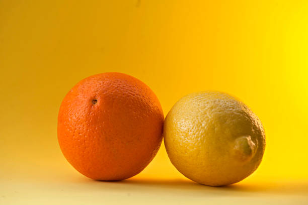 istock Orange and lemon on a yellow background 1248192223