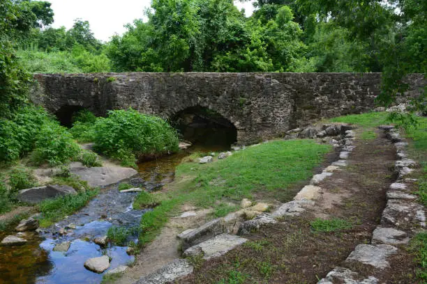 Historic aqueduct (acequia) spanning Piedras Creek of Mission Espada in San Antonio, TX is still in use today.