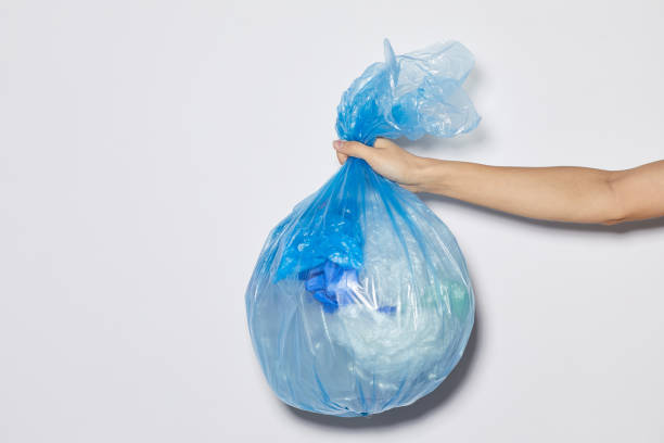 istock Woman holding garbage bag 1248193979