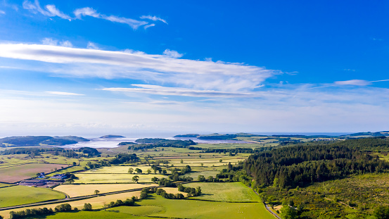 A panoramic image produced by merging three images.
The images were captured by a drone.
A view of the rural landscape with the coast in the background of Dumfries and Galloway in south west Scotland.