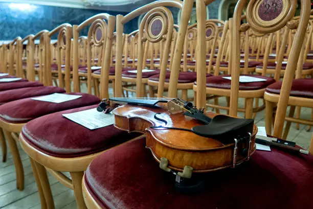 Photo of violin on stage before a symphonic classical concert