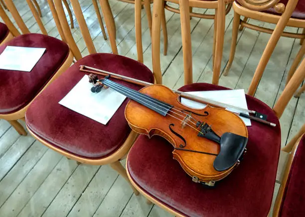 Photo of violin on stage before a symphonic classical concert