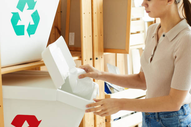 istock Woman recycling plastic bottles 1248194472