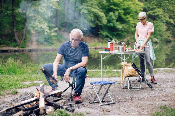 istock Senior couple camping by the river and enjoying 1248195500