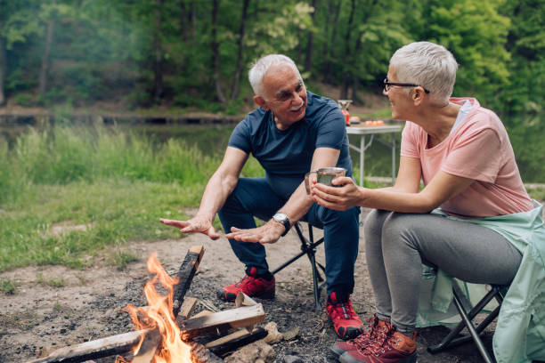 istock Senior couple enjoying by the fire during their camping vacation 1248195515