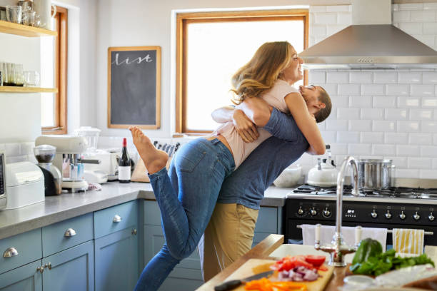 istock Loving couple enjoying leisure time in kitchen 1248195541