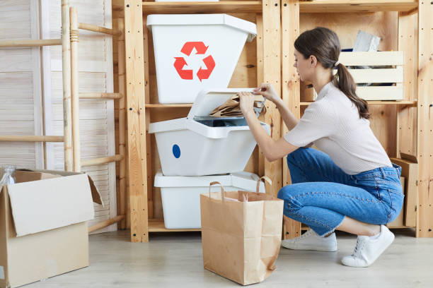 istock Woman separating paper from other waste 1248195560