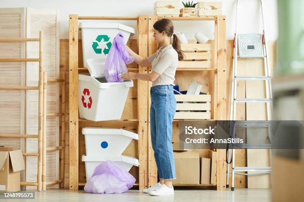 Woman Sorting Garbage Into Containers Stock Photo - Download Image Now - Garbage Bin, Living Room, Warehouse
