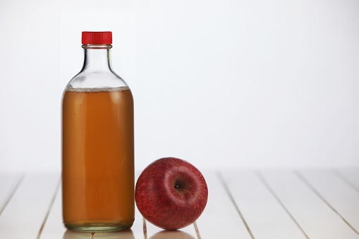 apple cider vinegar on white table top