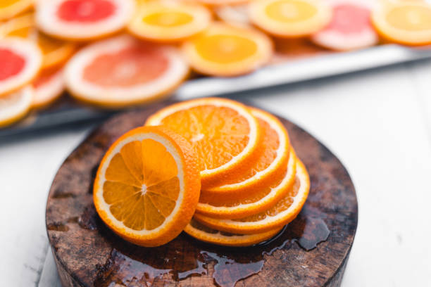 istock Sliced Oranges on the white wood background In the studio 1248197107
