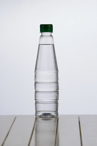 Mockup of three glass bottles. Blank white label on a glass water bottle. 3d render.