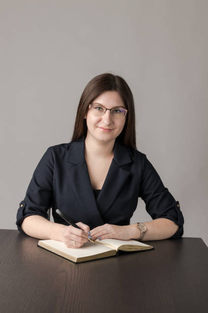 istock Young woman in blue is writing something. 1248197394