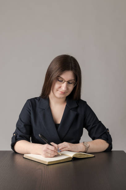 istock Young woman in blue is writing something. 1248197400