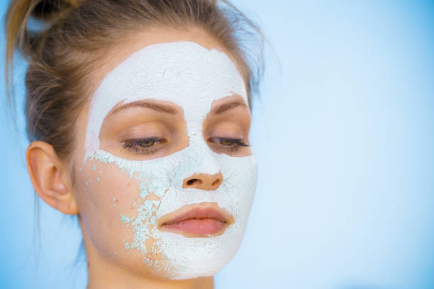 istock Girl removes dry white mud mask 1248198108
