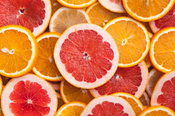 istock Sliced Grapefruit on the white wood background In the studio 1248198222