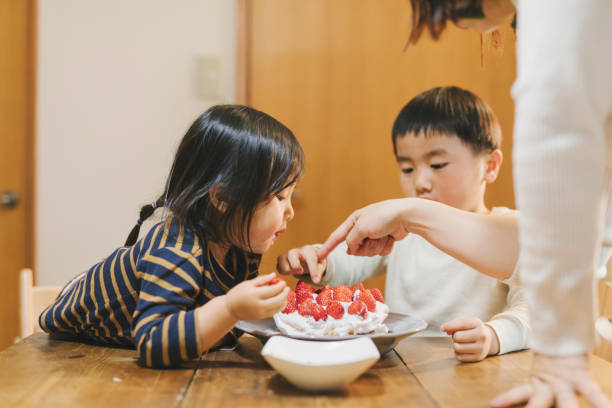 istock Family making a home made cake together 1248199486