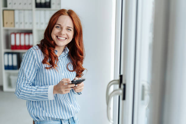 istock Cute friendly young woman grinning at camera 1248201999