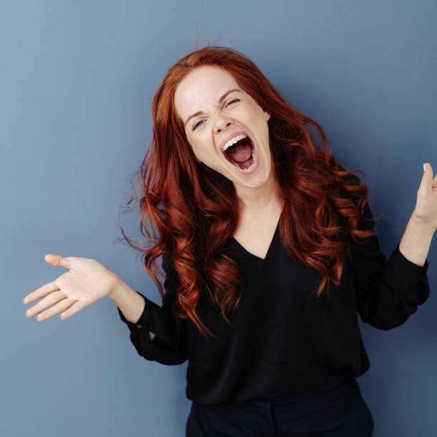 istock Young woman screaming and gesturing in frustration 1248202123