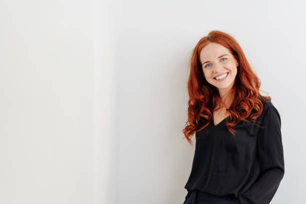 istock Smiling friendly young woman standing indoors 1248202125