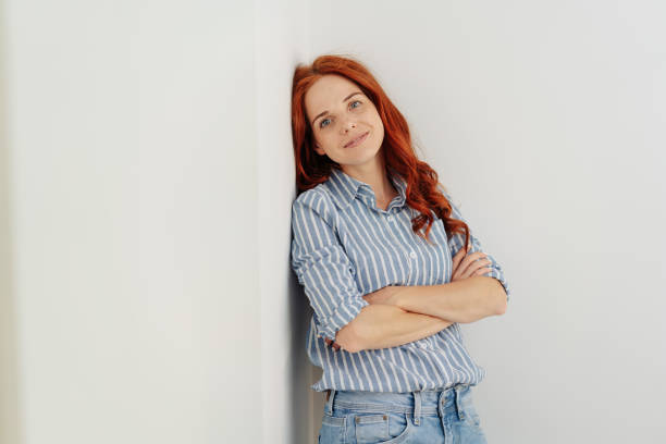 istock Thoughtful young woman standing staring at camera 1248202173