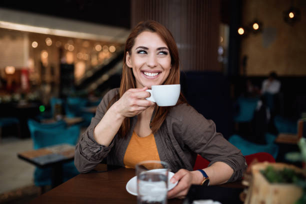 istock Beautiful young woman in coffee bar 1248202368