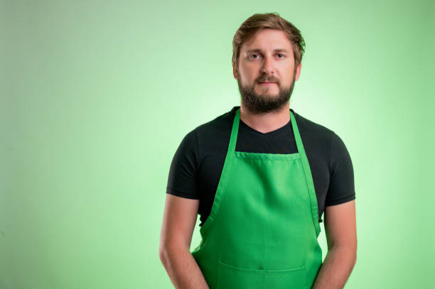 istock Supermarket employee with green apron 1248202497