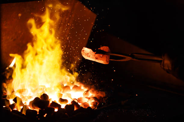Hot ore in a steel trough. A metal smelting plant.