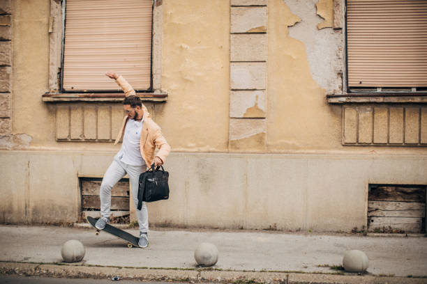istock Modern young businessman ridding skateboard to work 1248210415