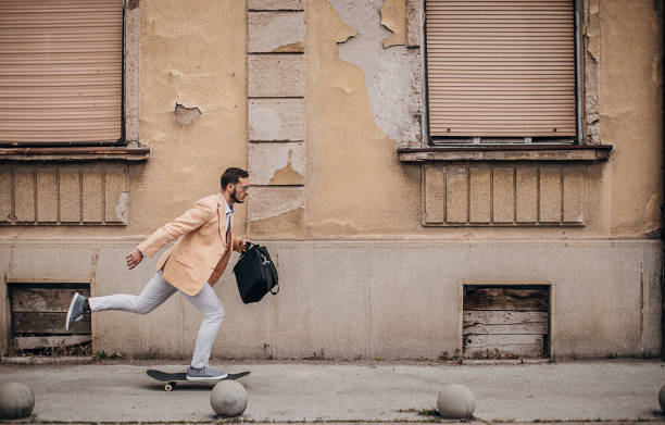 istock Modern young businessman ridding skateboard to work 1248210460