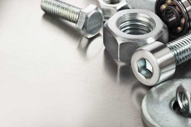 nuts, bolts, screws, washers, bearings on a metal steel background. nuts, bolts, screws, washers, bearings on a metal steel background. fastening photos stock pictures, royalty-free photos & images