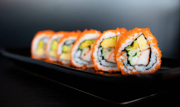istock Sushi roll on black background.  Japan food concept 1248212347