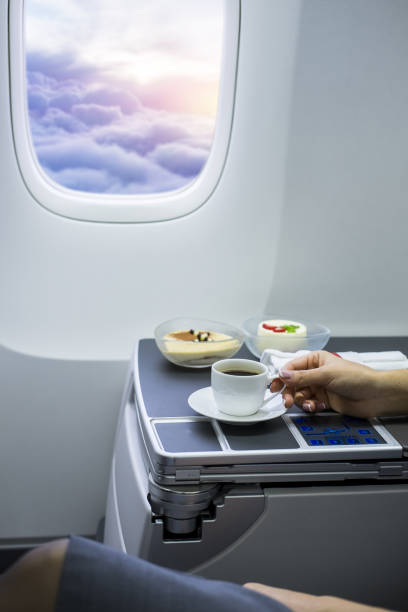 istock Cup of fresh espresso on table in airplane interior 1248212448