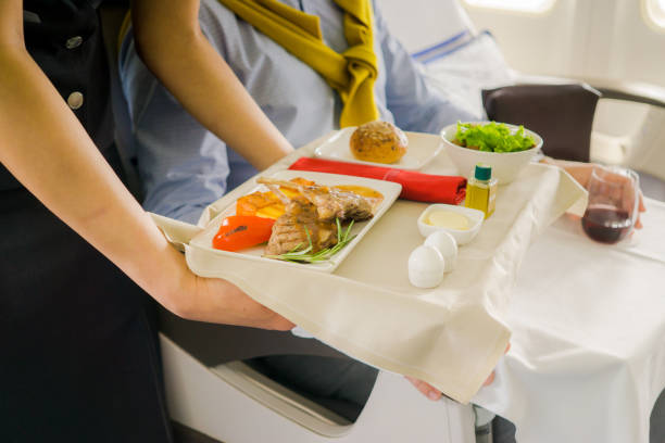 istock flight attendant serving meal in an airplane 1248213461