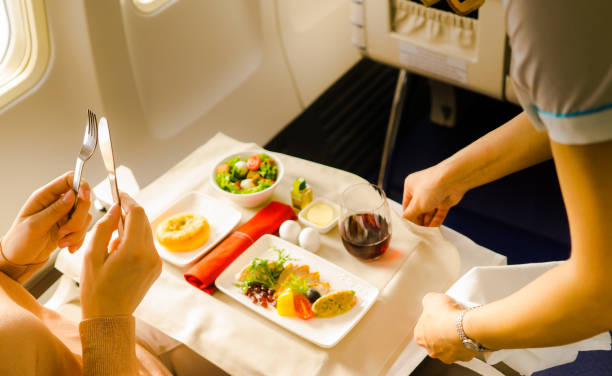 istock flight attendant serving meal in an airplane 1248213519