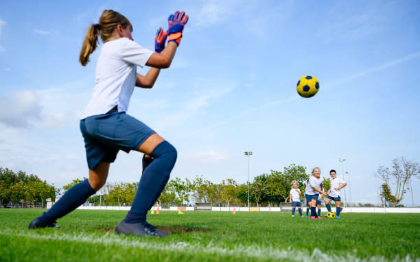 istock Young girl goalie defending against kicks in practice drill 1248213656