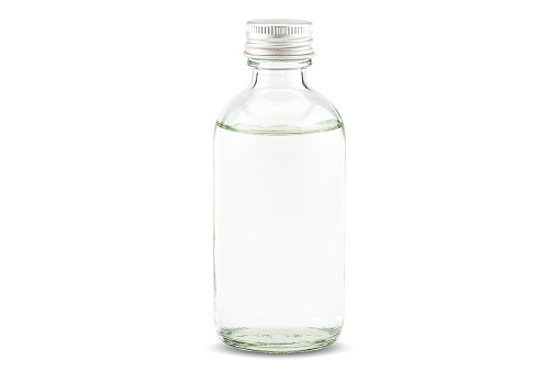 Cold pressed coconut oil in bottle on white background with clipping path